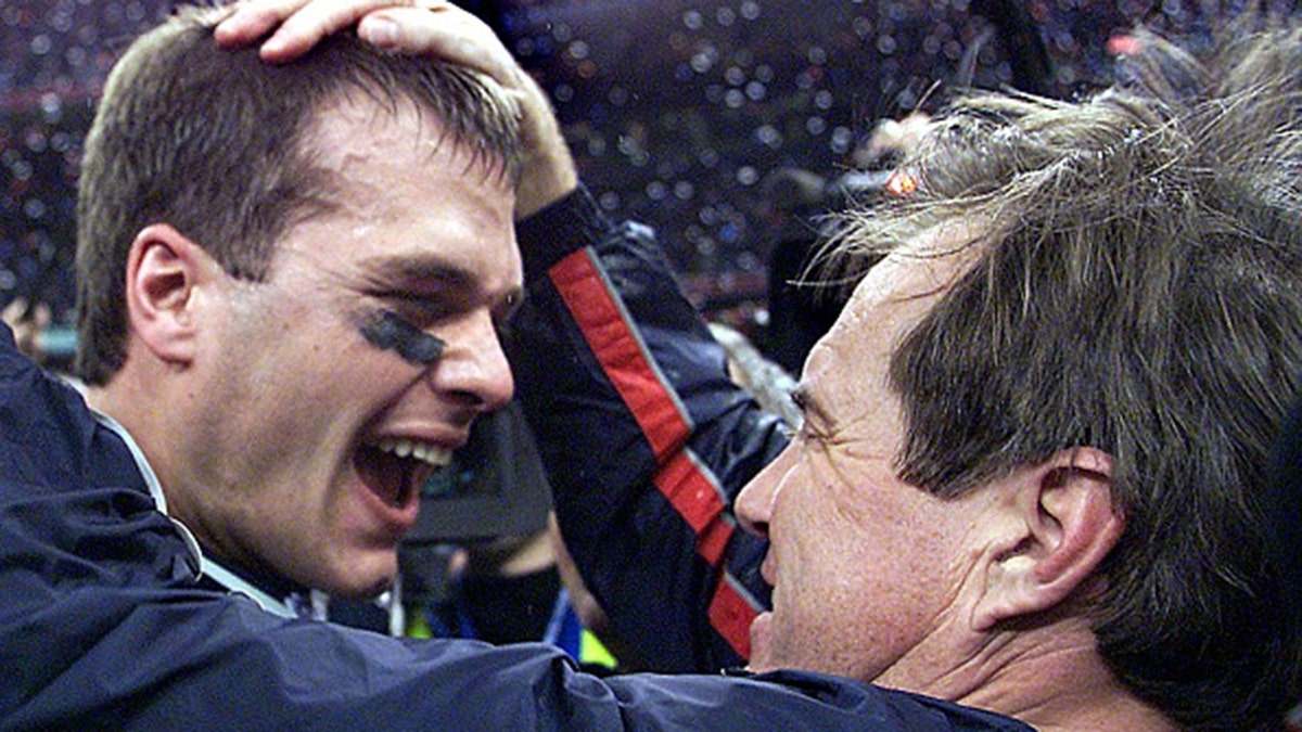 New England Patriots quarterback Tom Brady celebrates with head coach Bill Belichick (right) after their win over the St. Louis Rams, Feb. 3, 2002, in Super Bowl XXXVI in New Orleans, Louisiana.