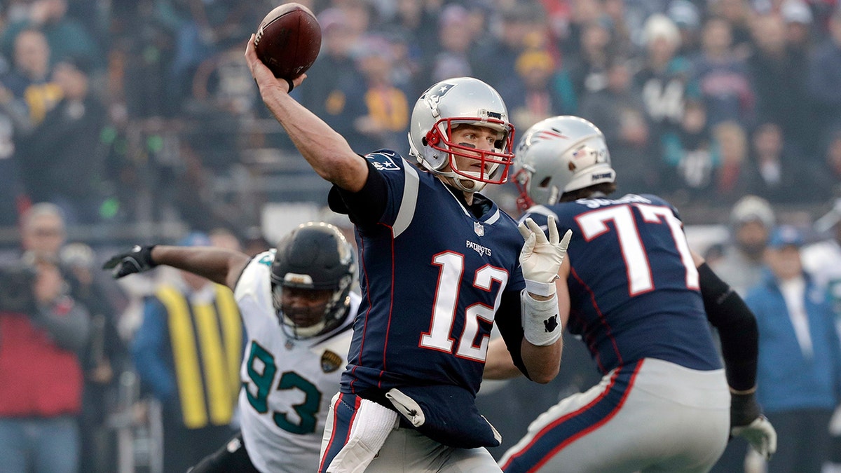 New England Patriots quarterback Tom Brady throws a pass under pressure during the first half of the AFC championship NFL football game, Sunday, Jan. 21, 2018, in Foxborough, Massachusetts.