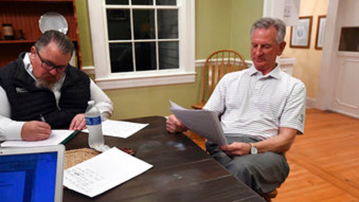 Alabama U.S. Senate candidate Tommy Tuberville, right, watches election returns and works on his speech in the main house at Auburn Oaks Farm, the site of his election party, Tuesday, March 3, 2020. Tuberville is in a tight race with seven competitors for the Senate seat. (Joe Songer/The Birmingham News via AP)