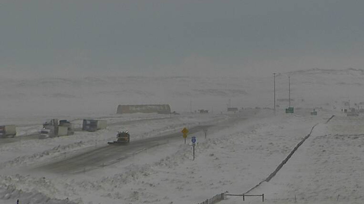 Trucks can be seen parked in the area of a major pileup on Interstate 80 in Wyoming on Monday.