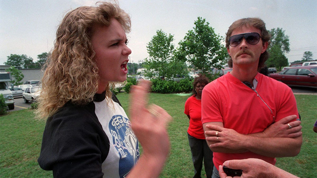 Photo circa 1993: "They're nothing but punks! punks! punks!'' shouted Pam Hobbs, the mother of Steve Branch, as she left the courtroom where the families of the three young victims came face-to-face with their children's accused killers. At right is her husband, Terry Hobbs.