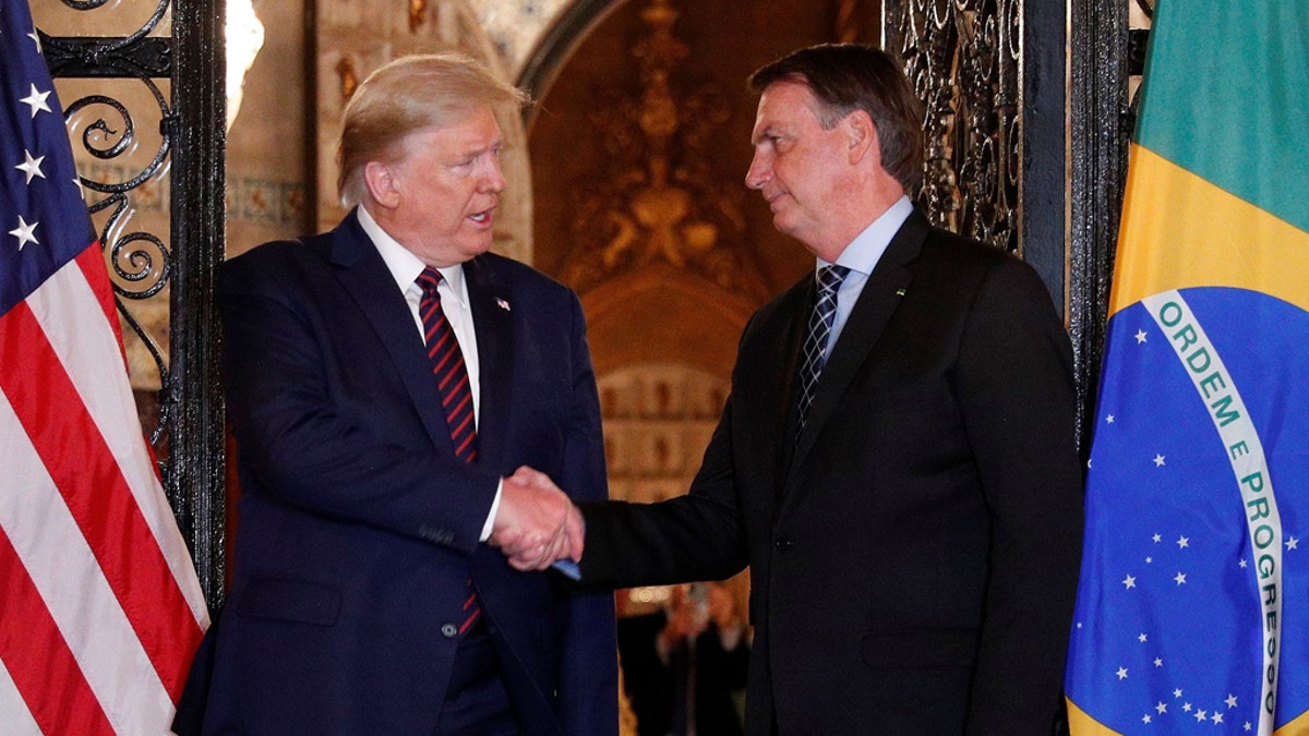 U.S. President Donald Trump shakes hands with Brazilian President Jair Bolsonaro before attending a working dinner at the Mar-a-Lago resort in Palm Beach, Florida, U.S., March 7, 2020. Picture taken March 7, 2020.