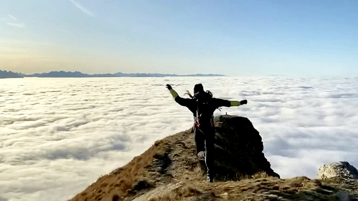 Amazing footage captured a woman jogging high above the clouds. (SWNS)