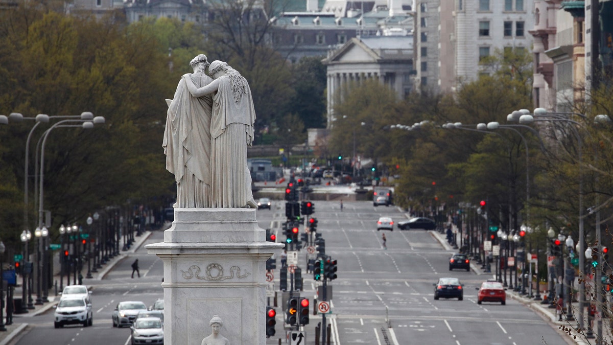 The Peace Monument faces a quiet Pennsylvania Avenue Northwest at rush hour, Monday, March 30, 2020, in Washington D.C.