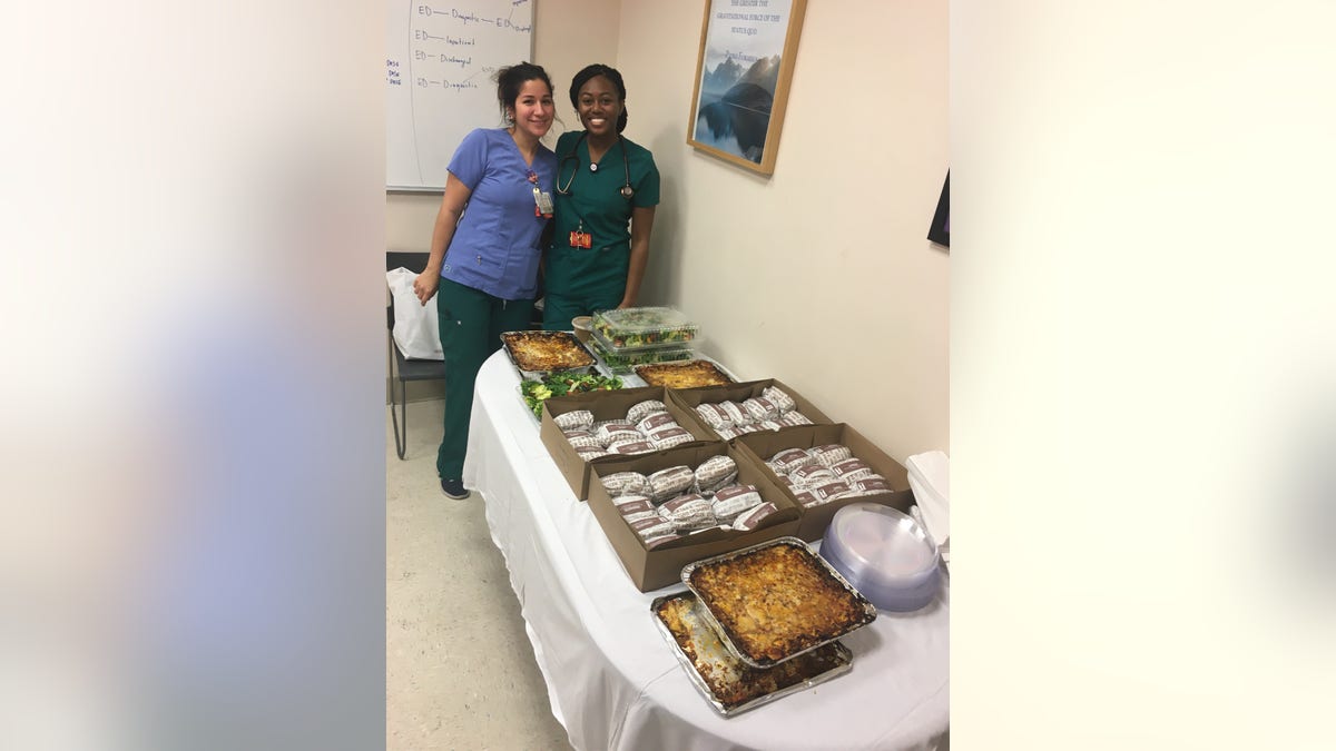 Health-care workers at NYU Langone Medical Center stand with donated meals from Tarallucci e Vino.