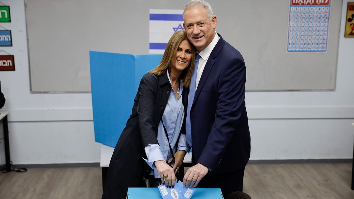 Gantz and his wife Revital vote in Rosh Haayin, Israel, on Monday in the country's third general election in less than a year. (AP Photo/Sebastian Scheiner)
