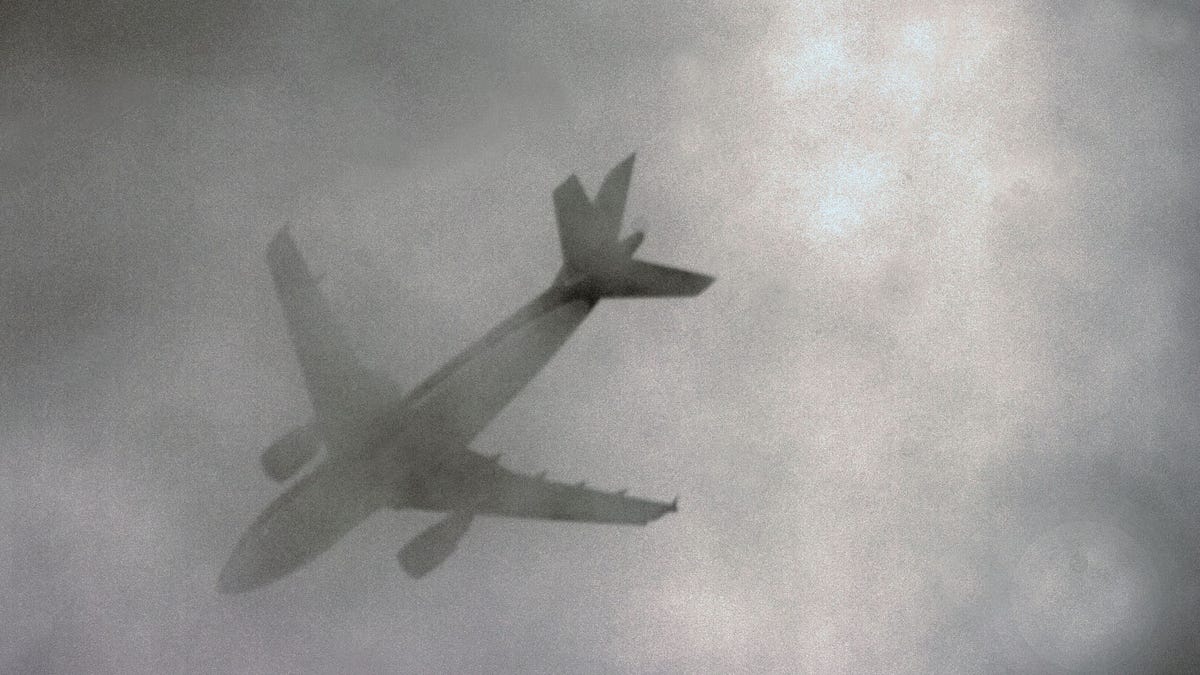 Airplane passing in low clouds