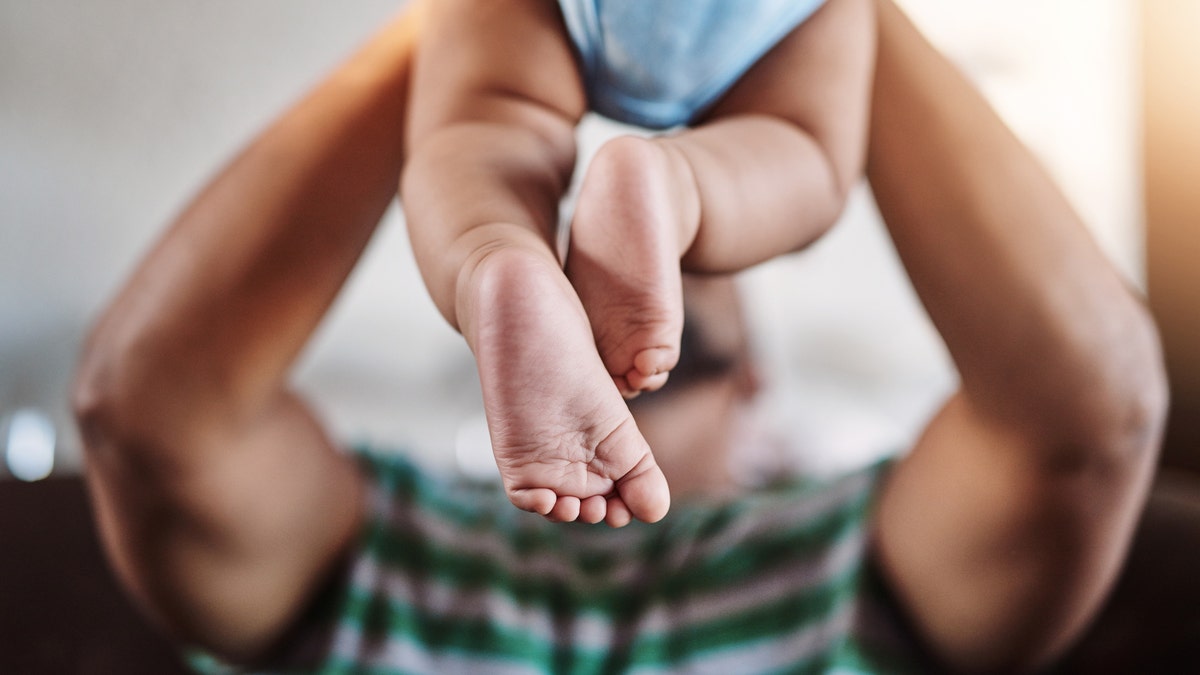 dad playing with baby