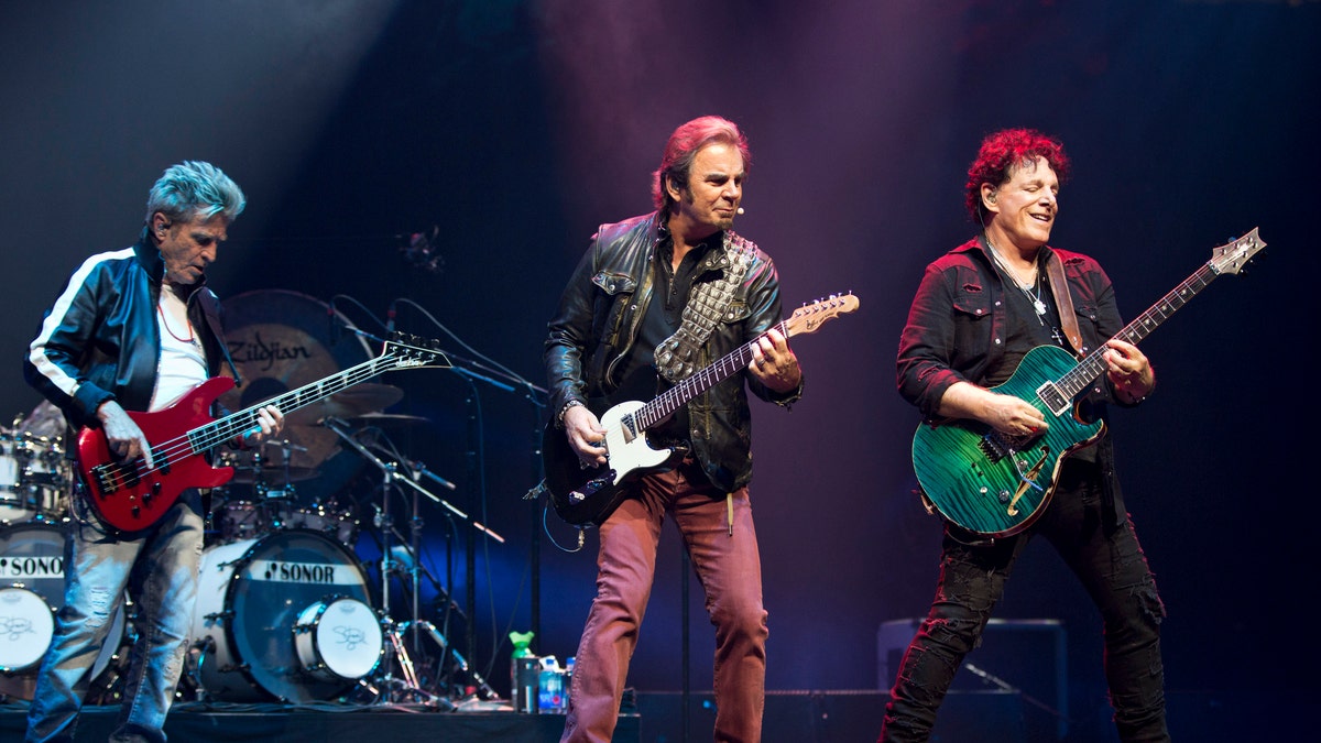 Journey's Ross Valory, Jonathan Cain and Neal Schon perform