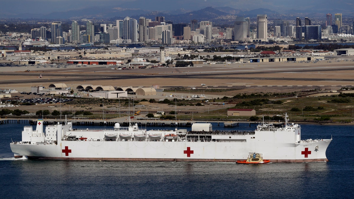 The USNS Mercy hospital ship leaves port Monday, March 23, 2020, in San Diego.