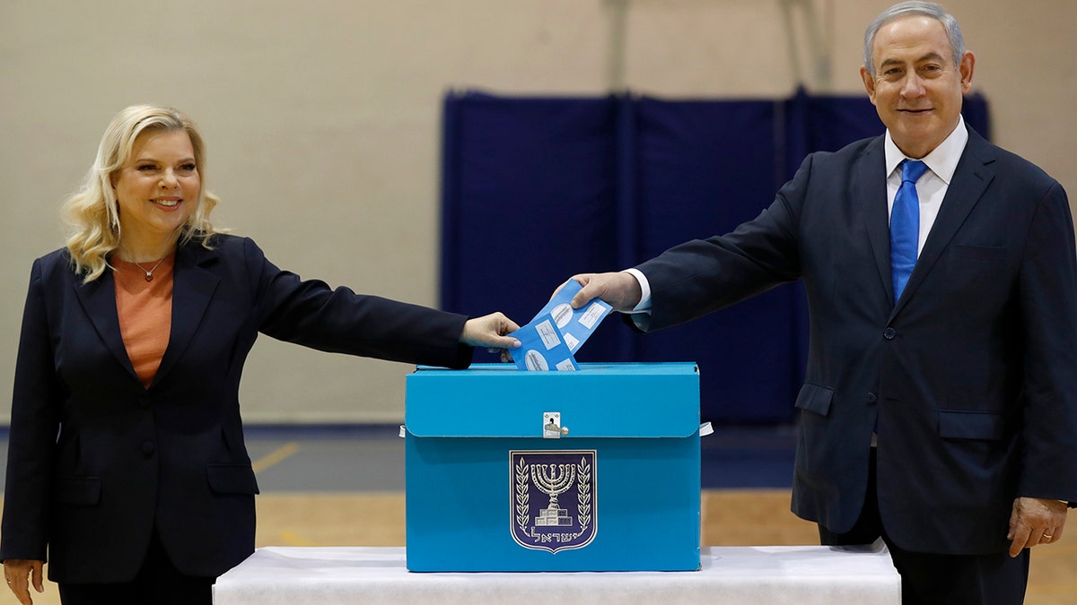 Netanyahu and his wife Sara cast their ballots during the Israeli legislative elections at a polling station in Jerusalem on Monday. (Atef Safadi/Pool Photo via AP)