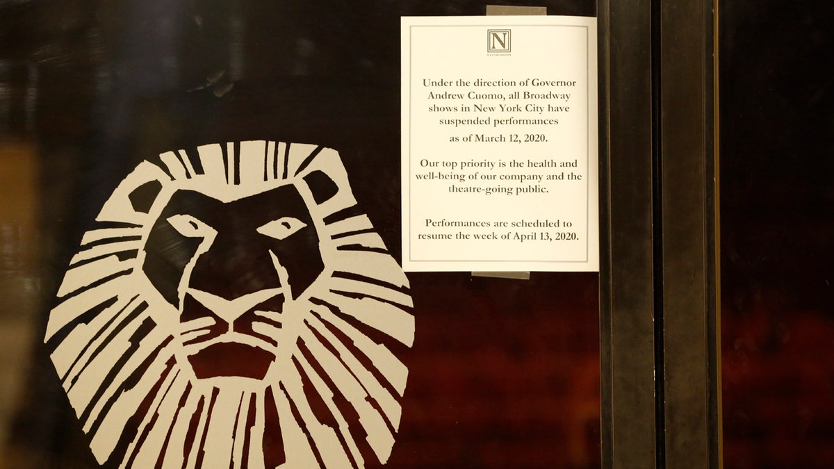 A sign announcing the suspension of all Broadway shows is posted on a door at the Minskoff Theatre, where "The Lion King" had been playing, Thursday, March 12, 2020, in New York. Gov. Andrew Cuomo banned gatherings of more than 500 people. (AP Photo/Kathy Willens)