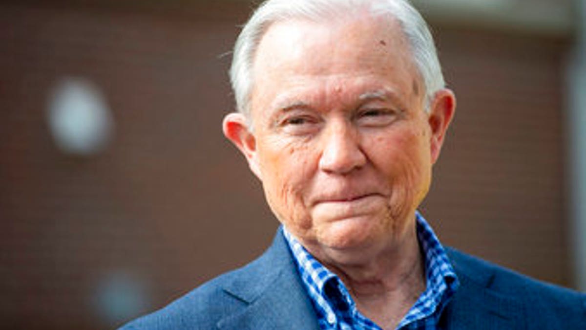 Jeff Sessions talks with the media after voting in Alabama's primary election, Tuesday, March 3, 2020, in Mobile, Ala. The former Attorney General is part of a seven person field in the state's Republican Senate primary, along with former Auburn University football coach Tommy Tuberville, U.S. Rep. Bradley Byrne and former Alabama Chief Justice Roy Moore, jockeying for the GOP nomination and the right to challenge Democratic Sen. Doug Jones in November. (AP Photo/Vasha Hunt)