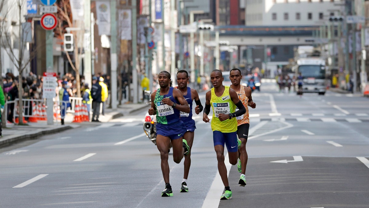 Ethiopia's Birhanu Legese, right in second row, races with other runners on his way to winning the Tokyo Marathon in Tokyo.