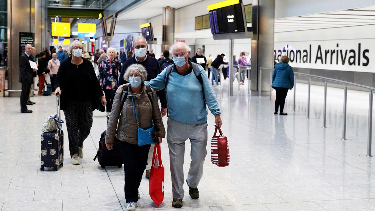Passengers from the coronavirus hit Braemar cruise ship return to Heathrow Airport in London, Thursday March 19, 2020.
