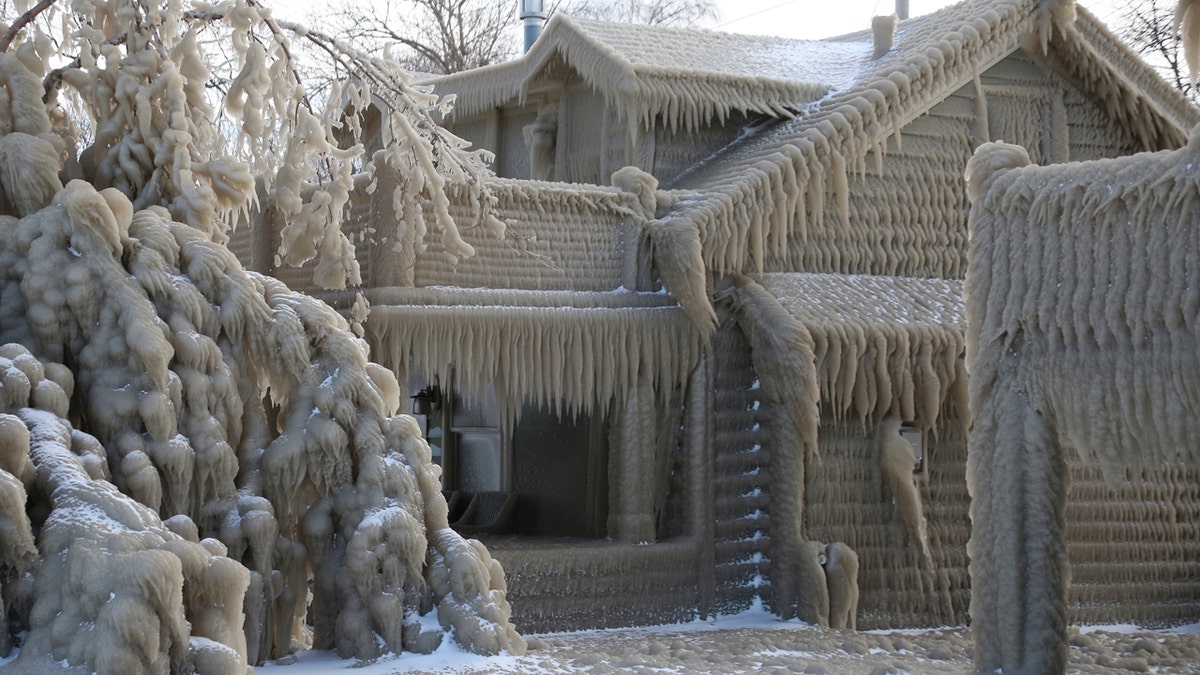 Houses along Hoover Beach is covered by ice from high winds and from the waves from Lake Erie, Saturday, Feb. 29, 2020, in Hamburg N.Y.