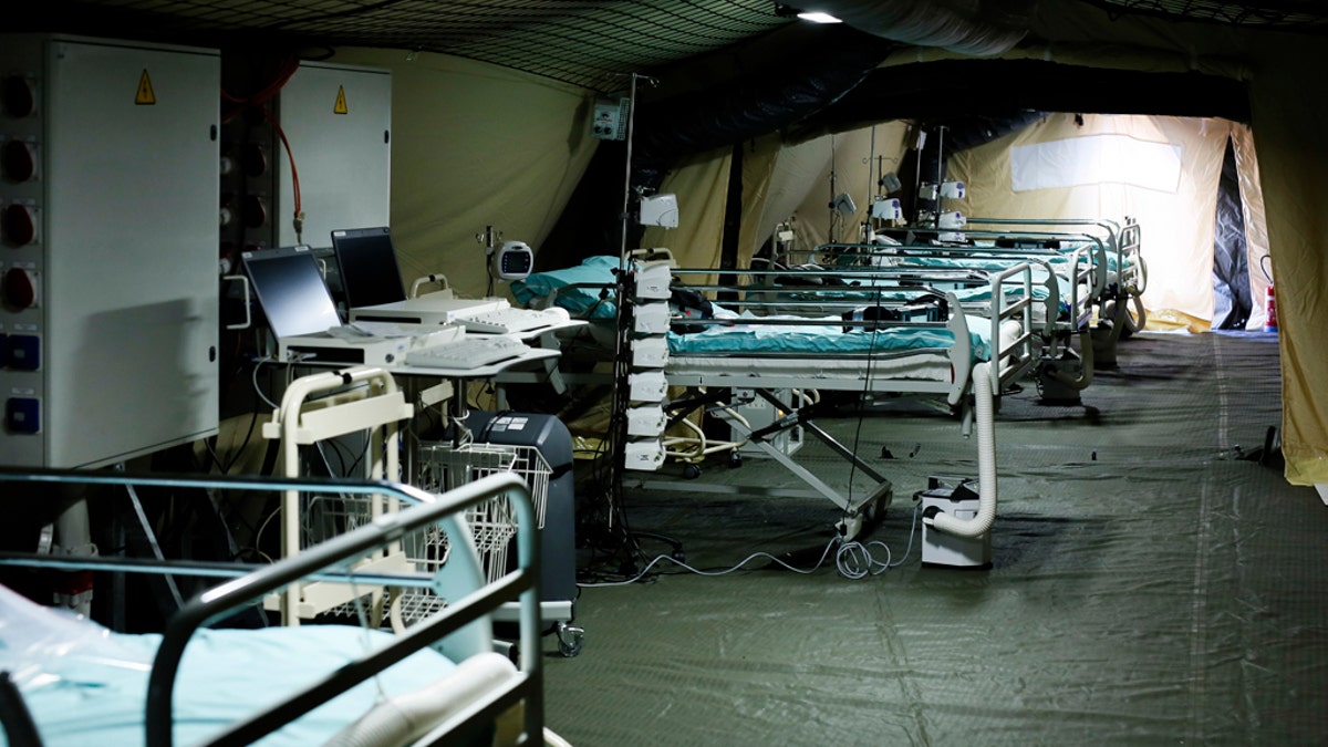 Beds line up at the military field hospital in eastern border city of Mulhouse on Tuesday. The Grand Est region is the epicenter of the outbreak in France. (Mathieu Cugnot, Pool via AP)