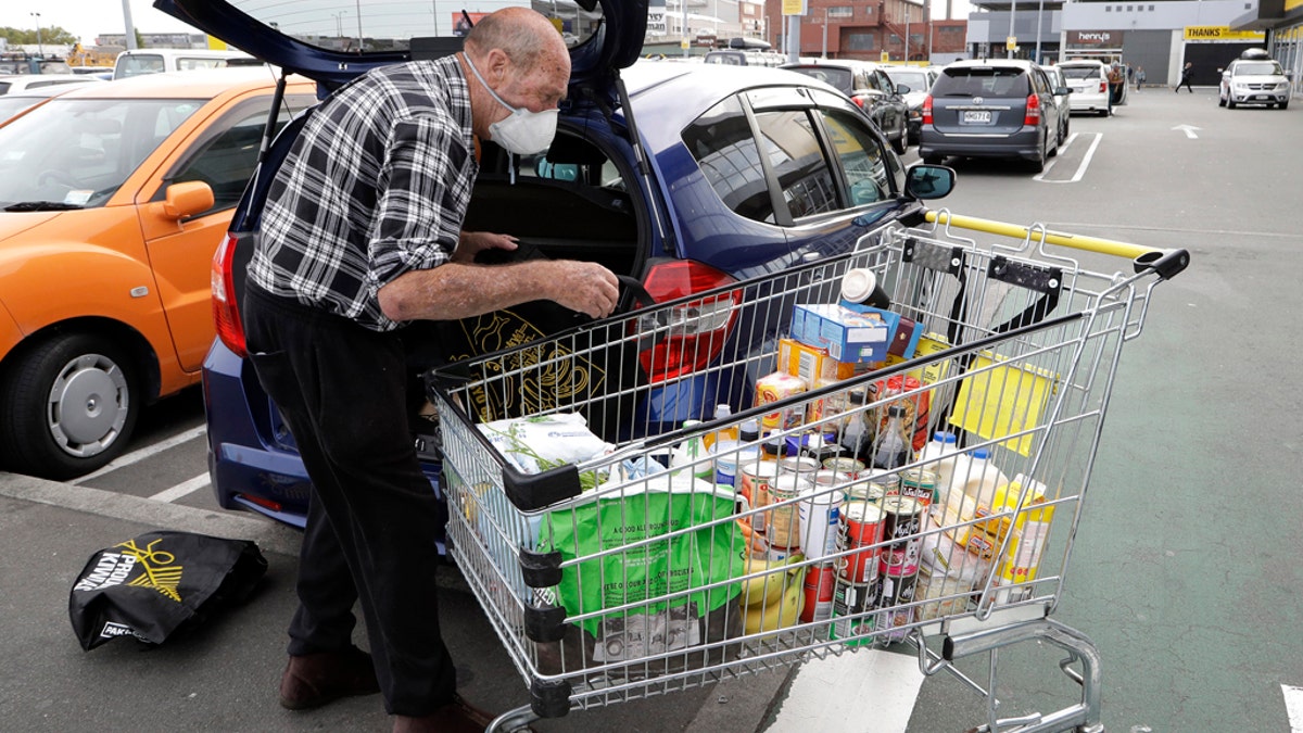 A man unpacks his shopping cart at a supermarket in central Christchurch, New Zealand, on Monday. New Zealand Prime Minister Jacinda Ardern announced the country would be going into full lockdown for about four weeks starting Wednesday. (AP)