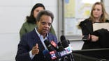Chicago Mayor Lori Lightfoot speaks to reporters Sunday, March 15, 2020, at O'Hare International Airport.  Harsh criticism rained on the Trump administration from state and local officials over long lines of returning international passengers at some U.S. airports that could have turned them into coronavirus carriers as they tried to get home. Mayor Lightfoot lambasted the administration for allowing about 3,000 Americans returning from Europe to be stuck for hours inside the customs area at O'Hare International Airport on Saturday, violating federal recommendations that people practice “social distance." (AP Photo/Teresa Crawford)