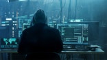 A hacker works on a computer.