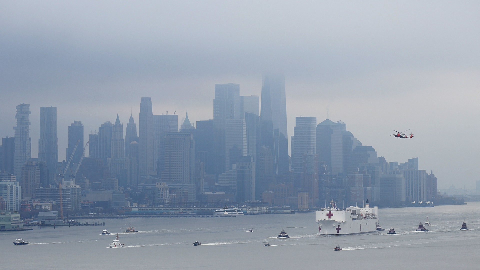 The USNS Comfort sails up the Hudson River past Lower Manhattan as it arrives in New York City, March 30, 2020.