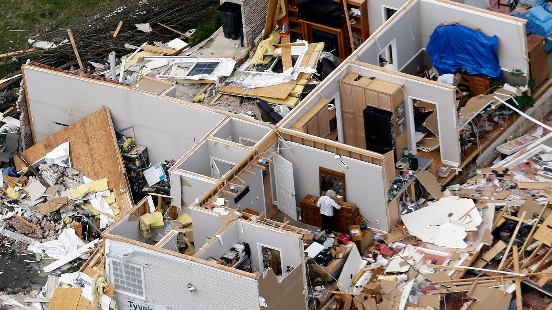 A woman salvages items from a tornado destroyed home in Lebanon, Tenn., March 3, 2020.
