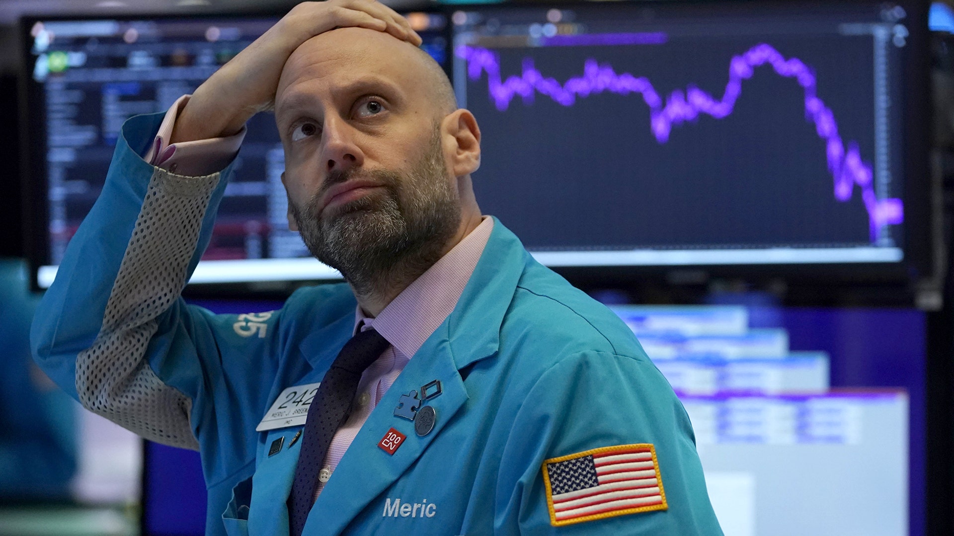 Meric Greenbaum a trader with Designated Market Maker IMC Financial looks up at the board before the opening bell before trading was halted on the New York Stock Exchange in New York City, March 9, 2020.