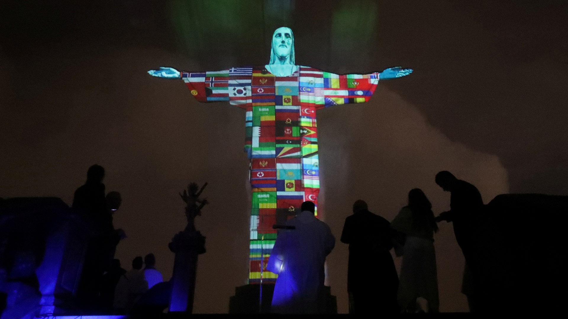 The Christ the Redeemer statue is lit up in the colors of the countries that are affected by the coronavirus outbreak in Rio de Janeiro, March 18, 2020. 
