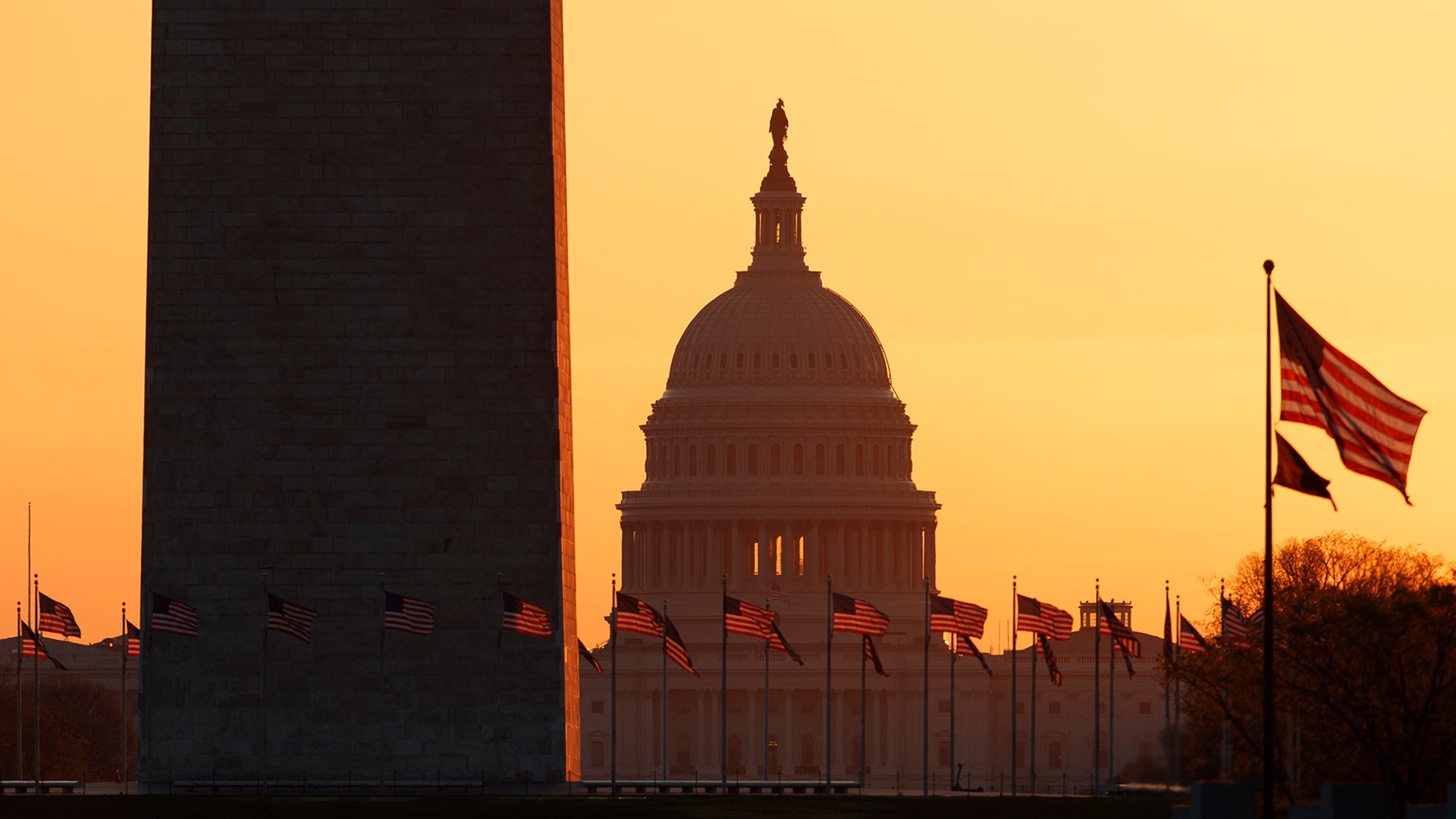 The Washington Monument and the U.S. Capitol are seen at sunrise in Washington, March 18, 2020. 