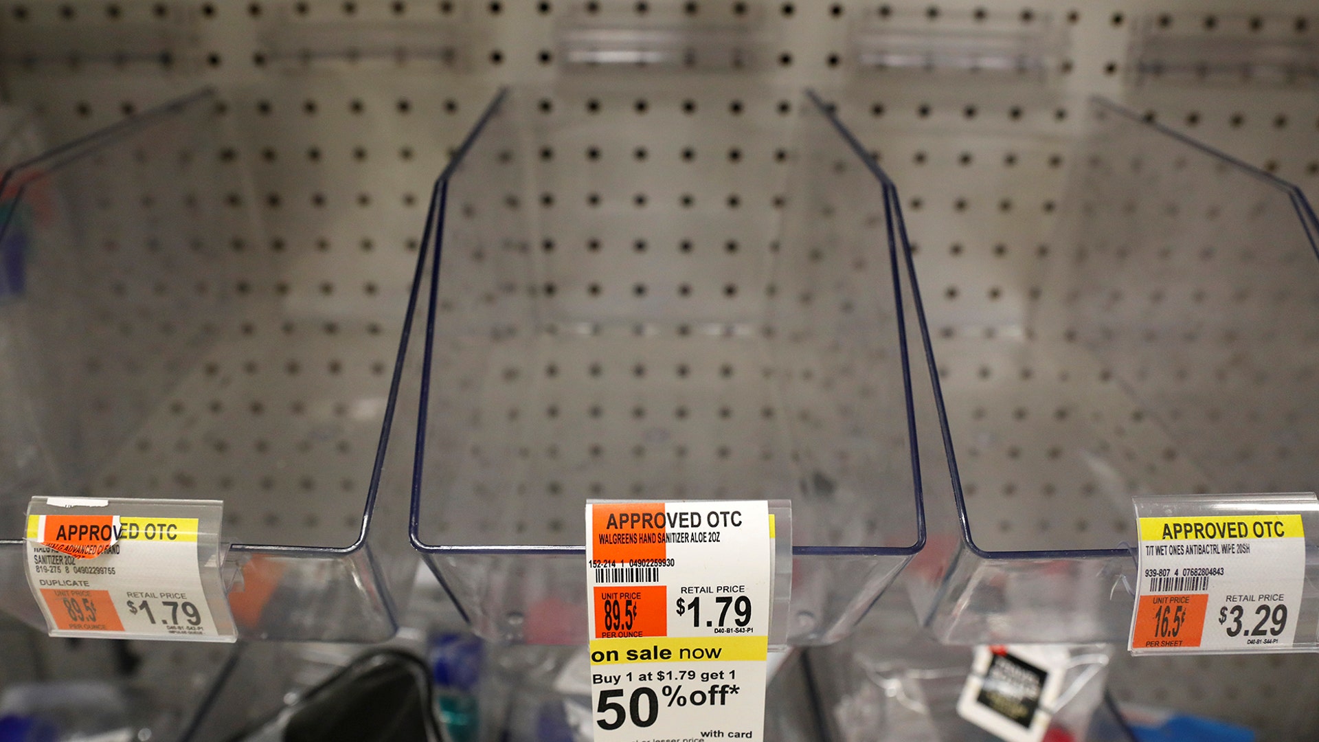 Empty bins that usually contain hand sanitizer products are seen in a store in New York City, Mar. 3, 2020.