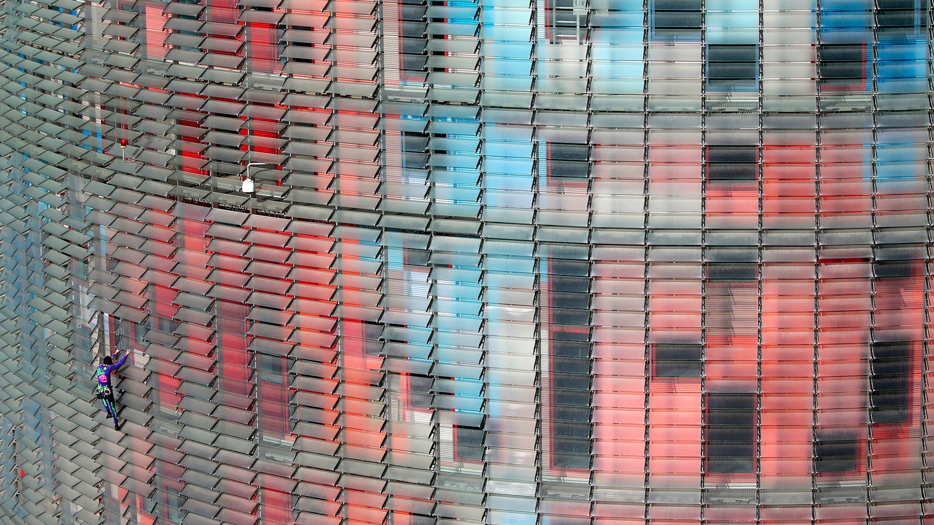French urban climber, Alain Robert, scales the 472 ft Glories Tower in Barcelona, Spain, March 4, 2020. 