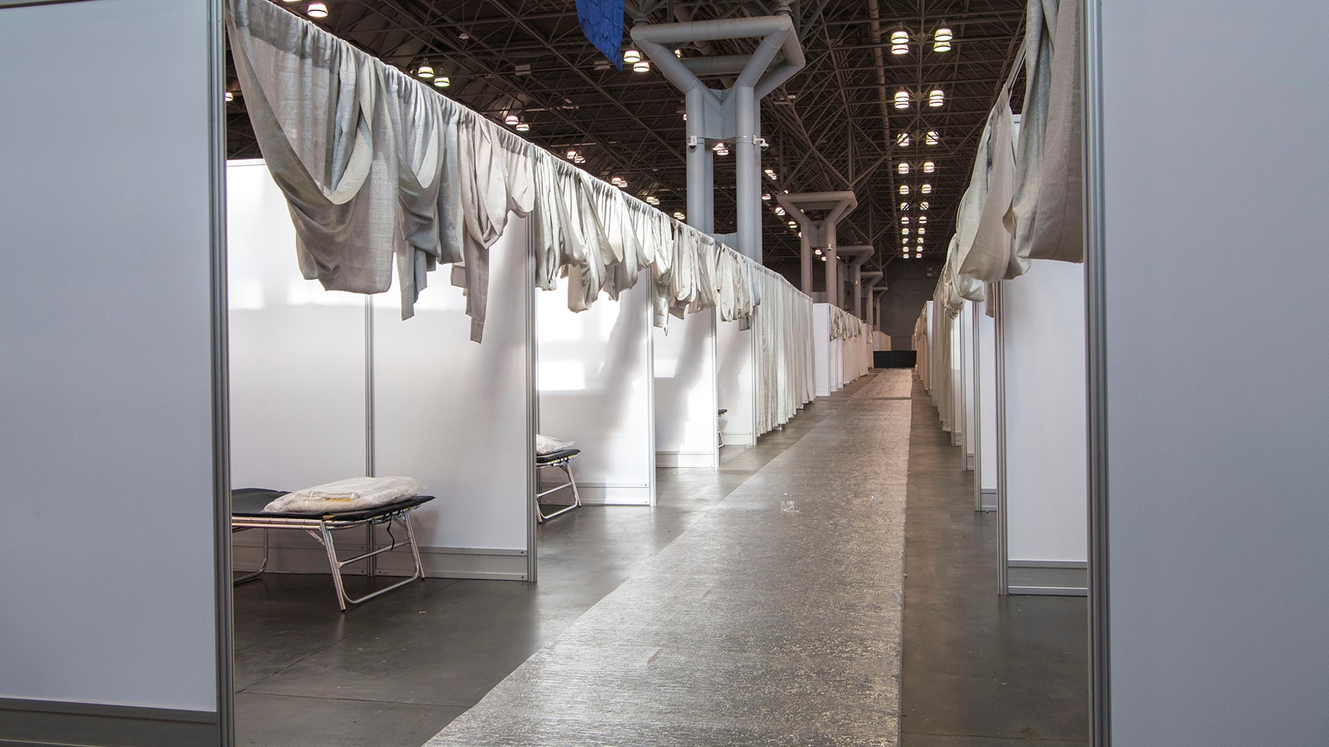 Makeshift hospital rooms stretch out along the floor at the Jacob Javits Convention Center in New York, March 27, 2020.