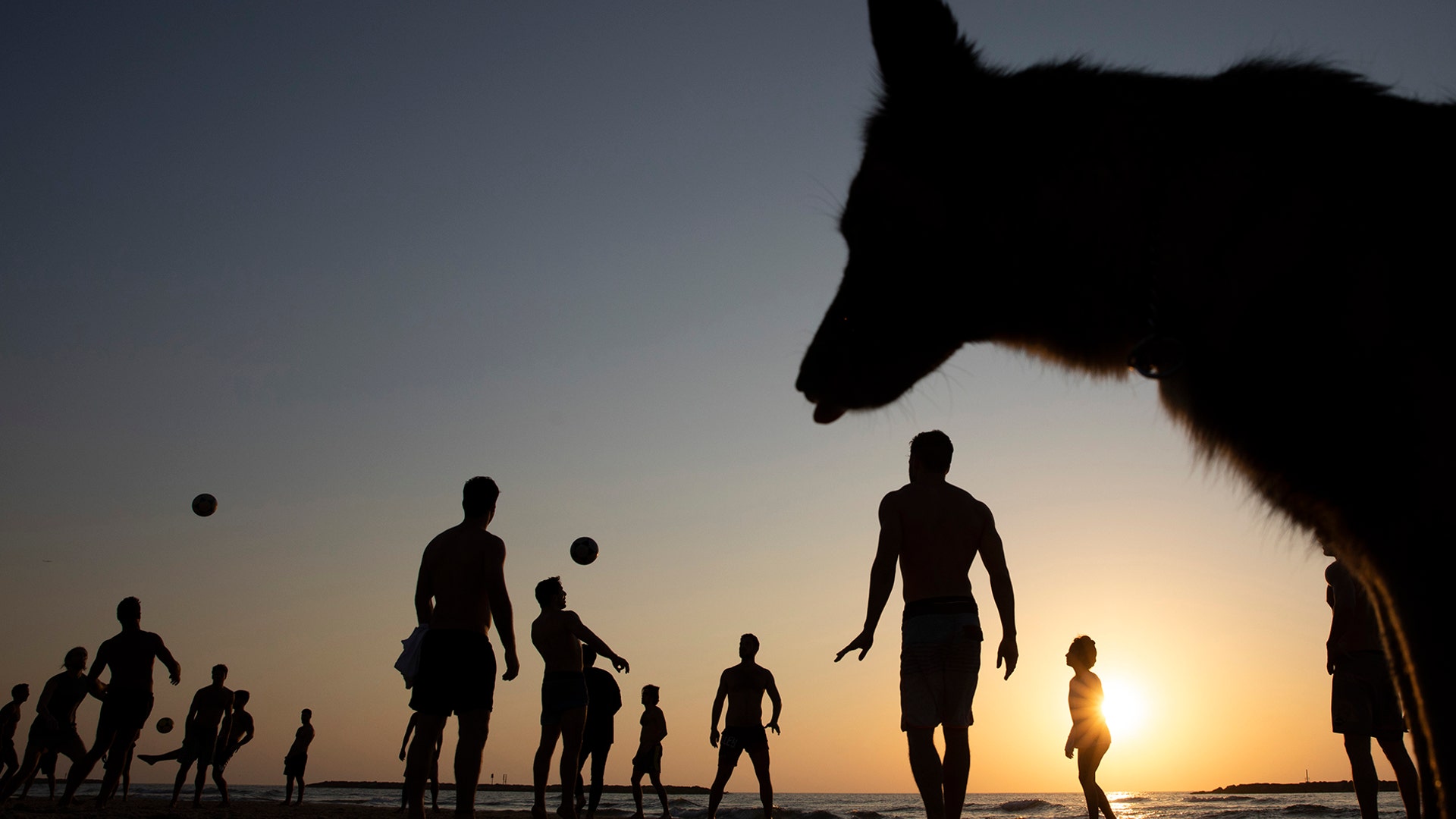 People play soccer at the Mediterranean Sea beachfront, in Tel Aviv, Israel, March 16, 2020. 