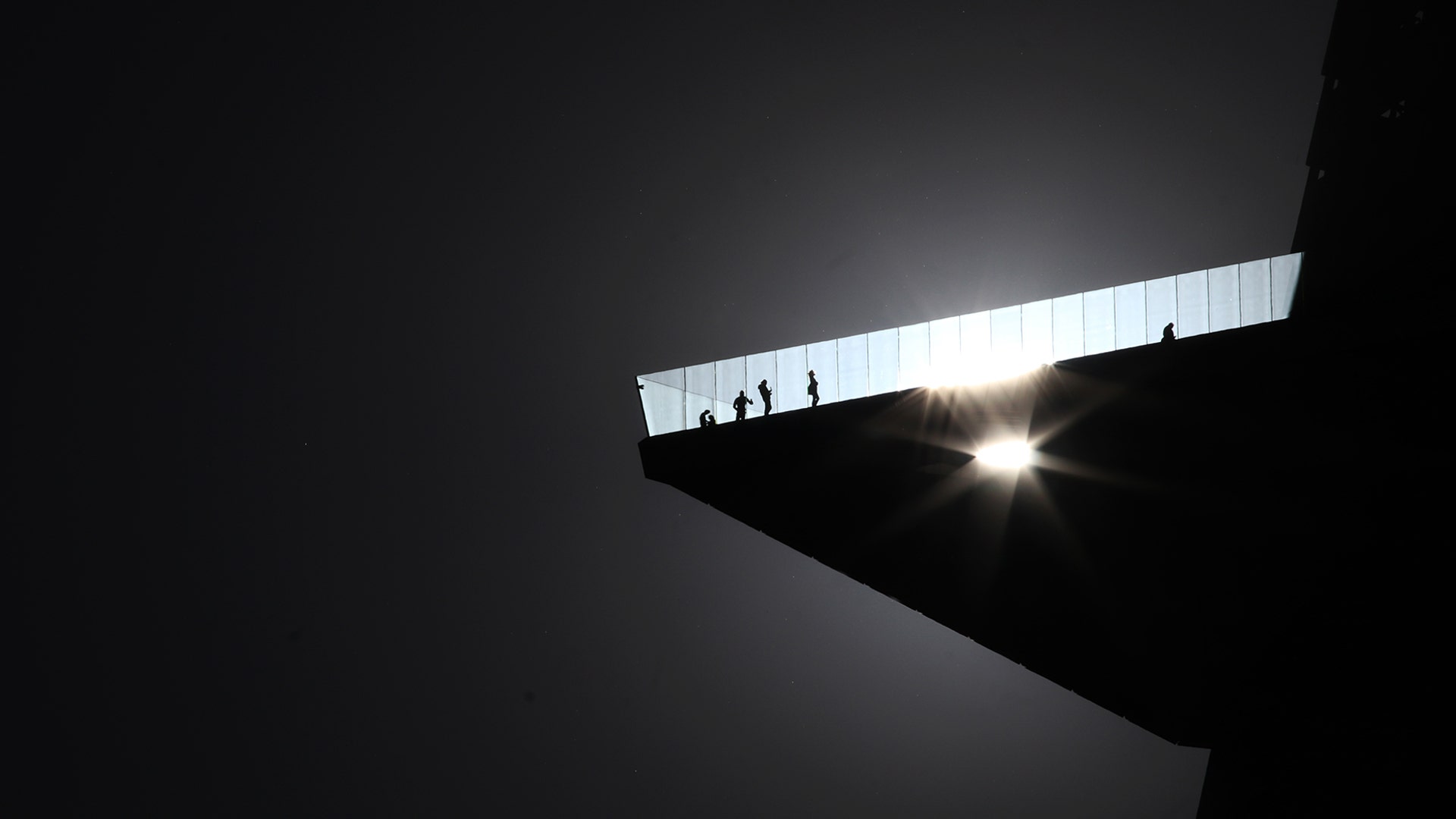 The sun shines through the glass floor of the Edge NYC as people stand on the outdoor observation deck 100 floors high at the top of 30 Hudson Yards in New York City, March 9, 2020. 