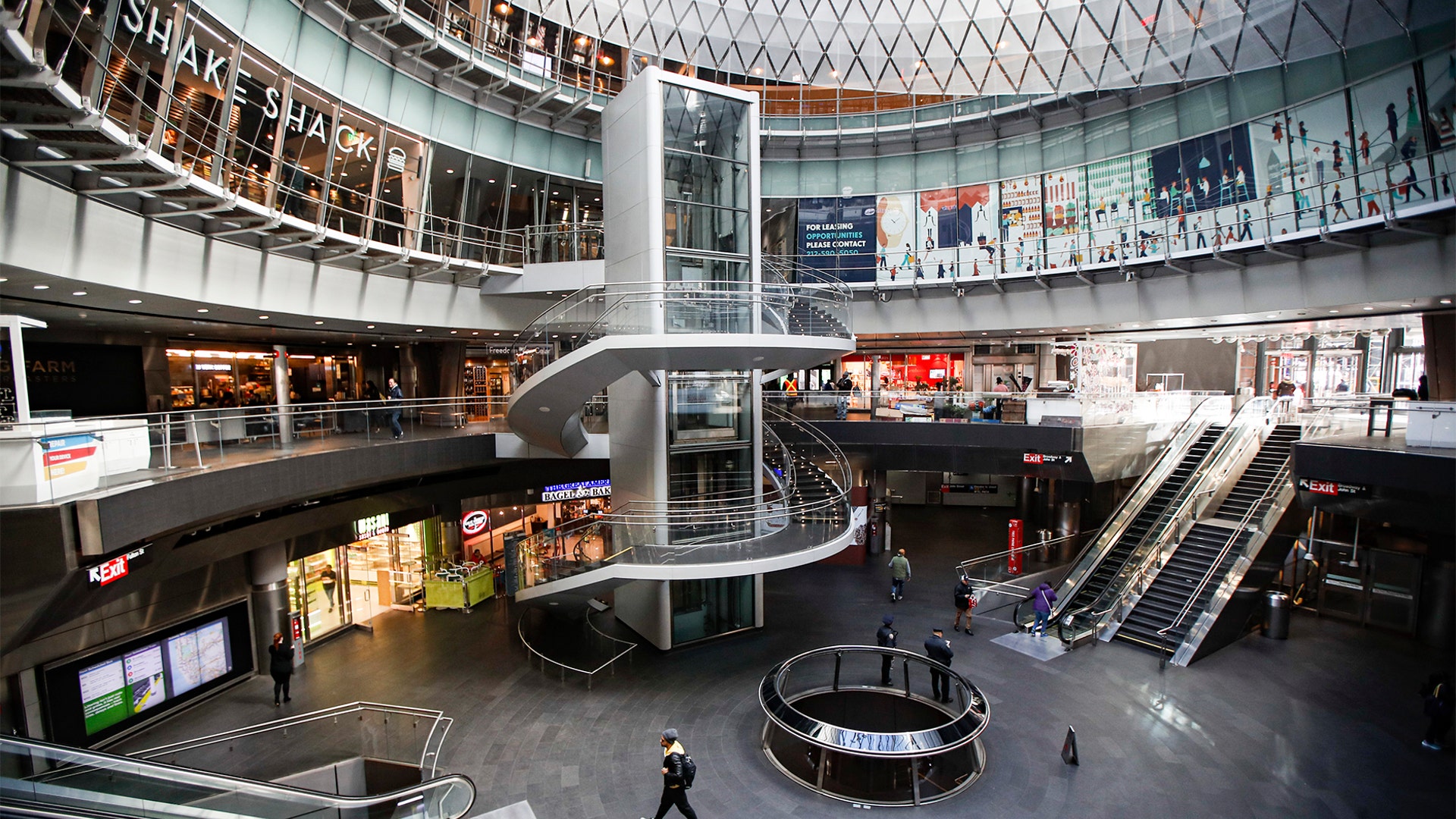 A pedestrian passes a nearly empty Fulton Center station as businesses are closed due to coronavirus concerns in New York, March 16, 2020.