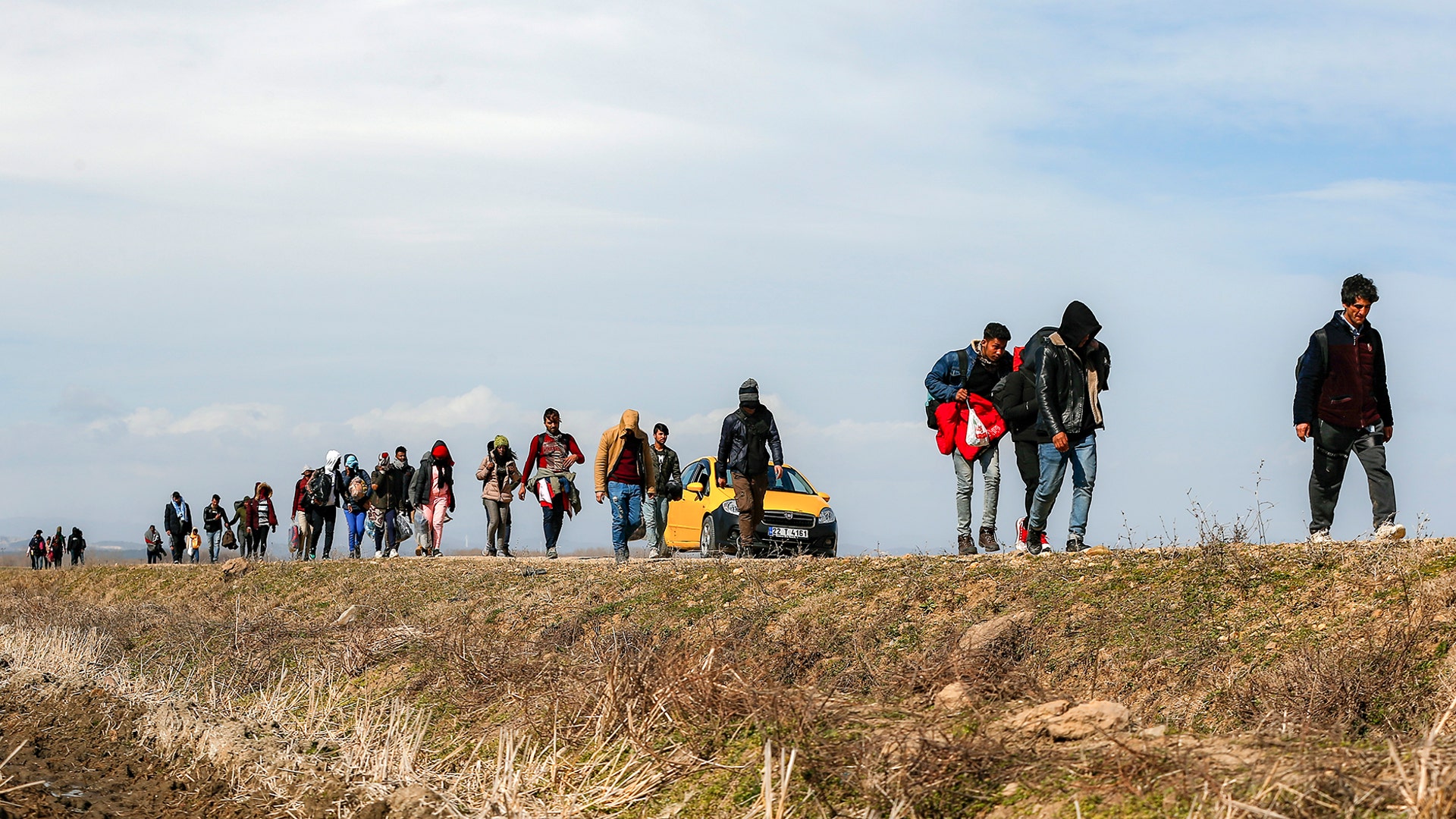 Migrants walk on a road near the Ipsala border gate in Edirne, at the Turkish-Greek border, March 3, 2020. 