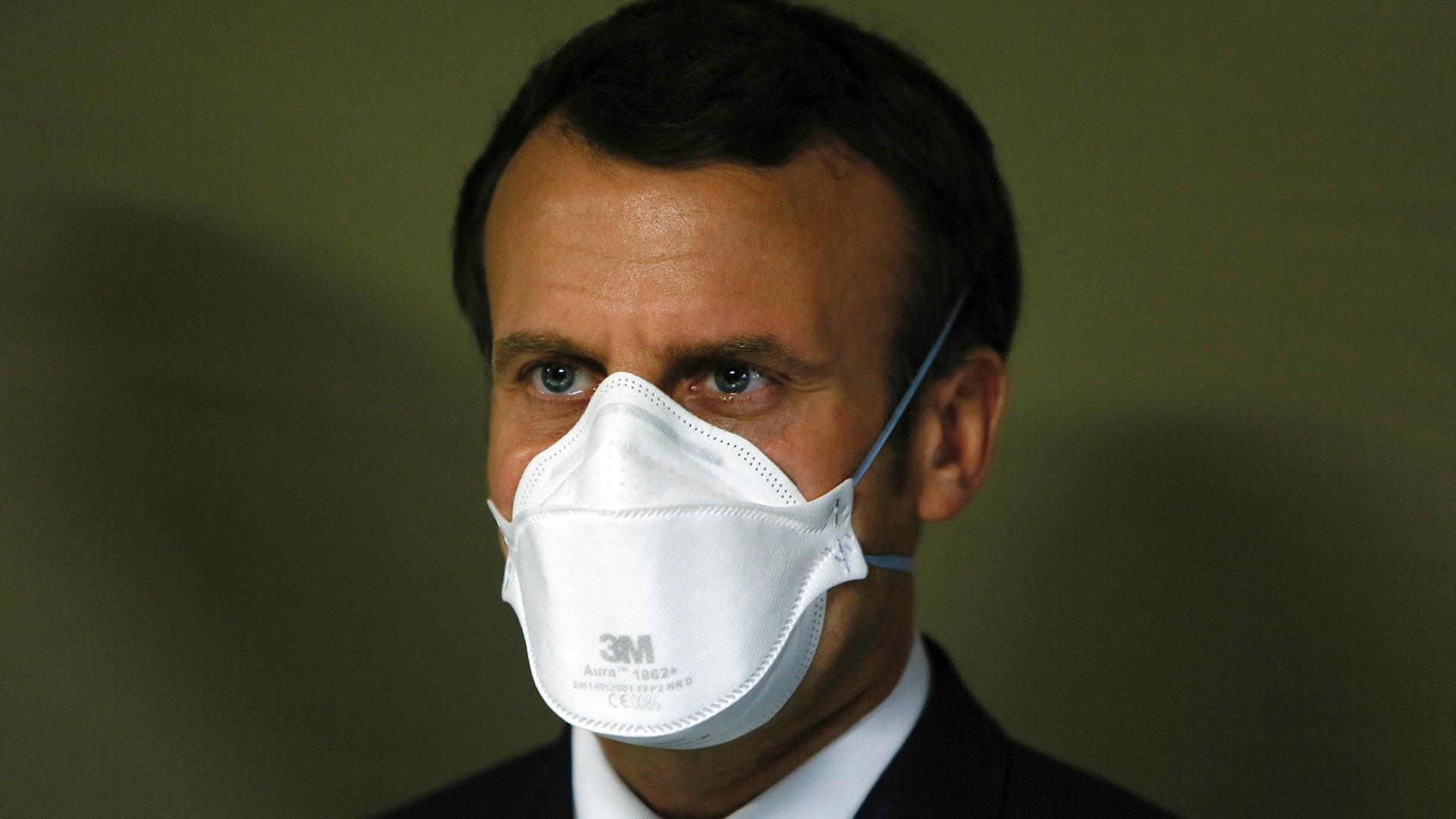 French President Emmanuel Macron wears a face mask during a visit at the military field hospital in Mulhouse, France, March 25, 2020. 