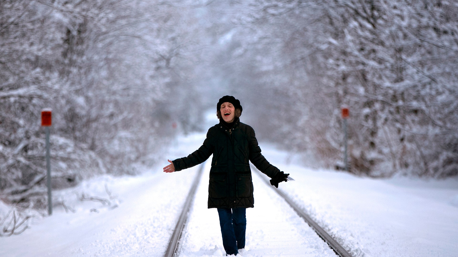 Ellen Werner enjoys the snow-covered landscape following an early spring snowstorm that dumped several inches of heavy, wet snow in Freeport, Maine, March 24, 2020. 