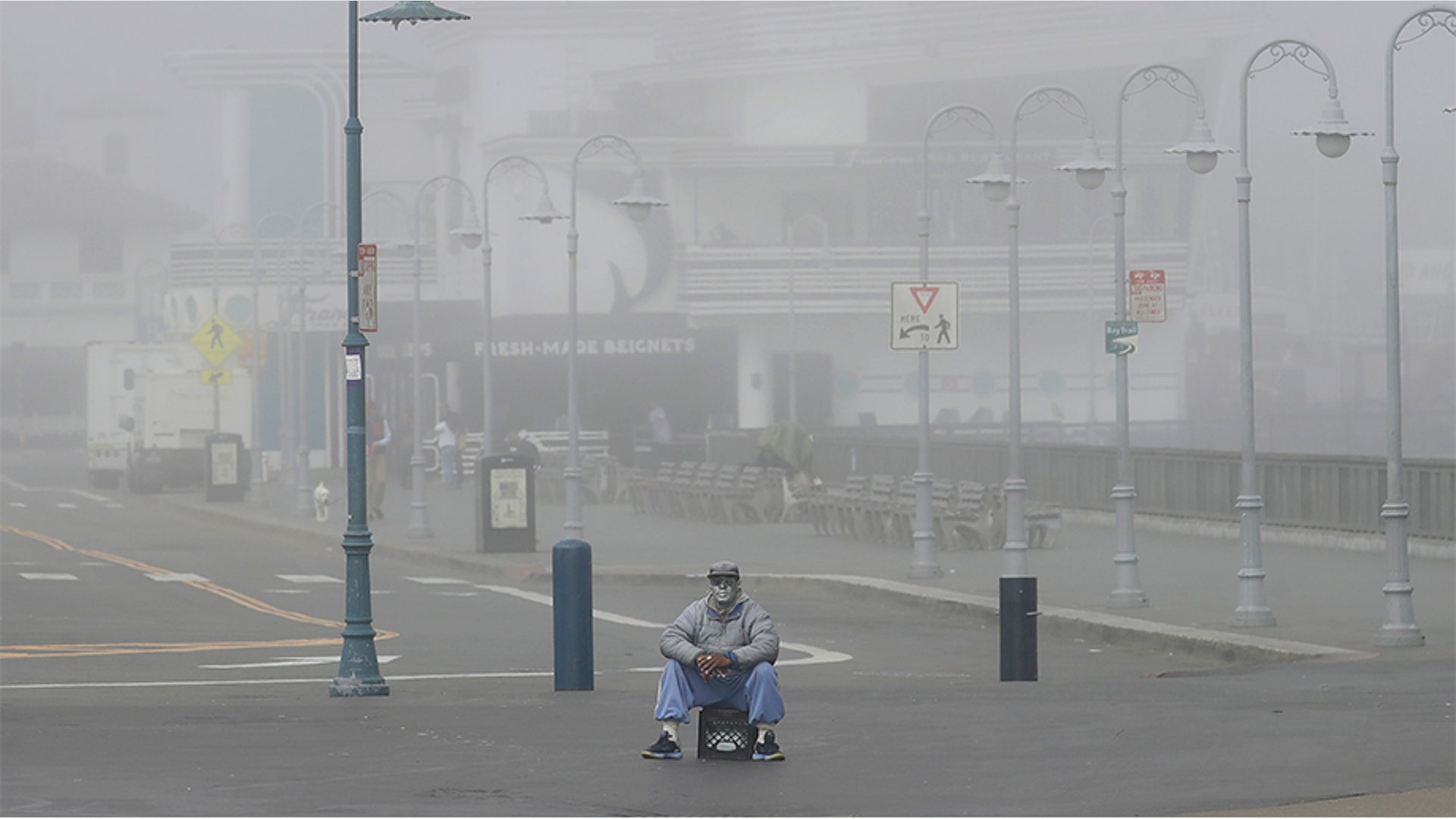 San Francisco, California: A street performer sitting alone at Fisherman's Wharf Thursday, March 12, 2020.