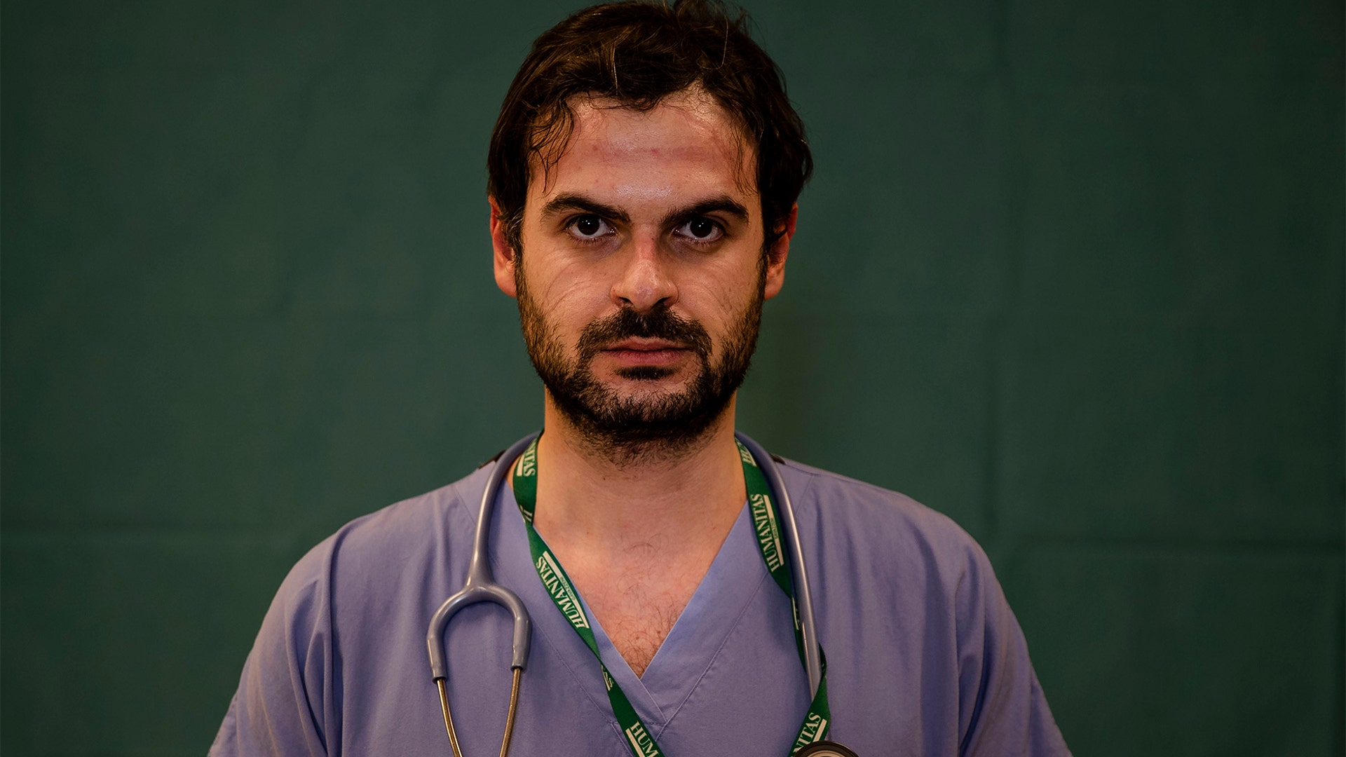 Alessandro D'Aveni, 33, an oncologist working in the COVID sub-intensive care unit at the Humanitas Gavazzeni Hospital, poses for a portrait at the end of his shift in Bergamo, Italy, March 27, 2020.