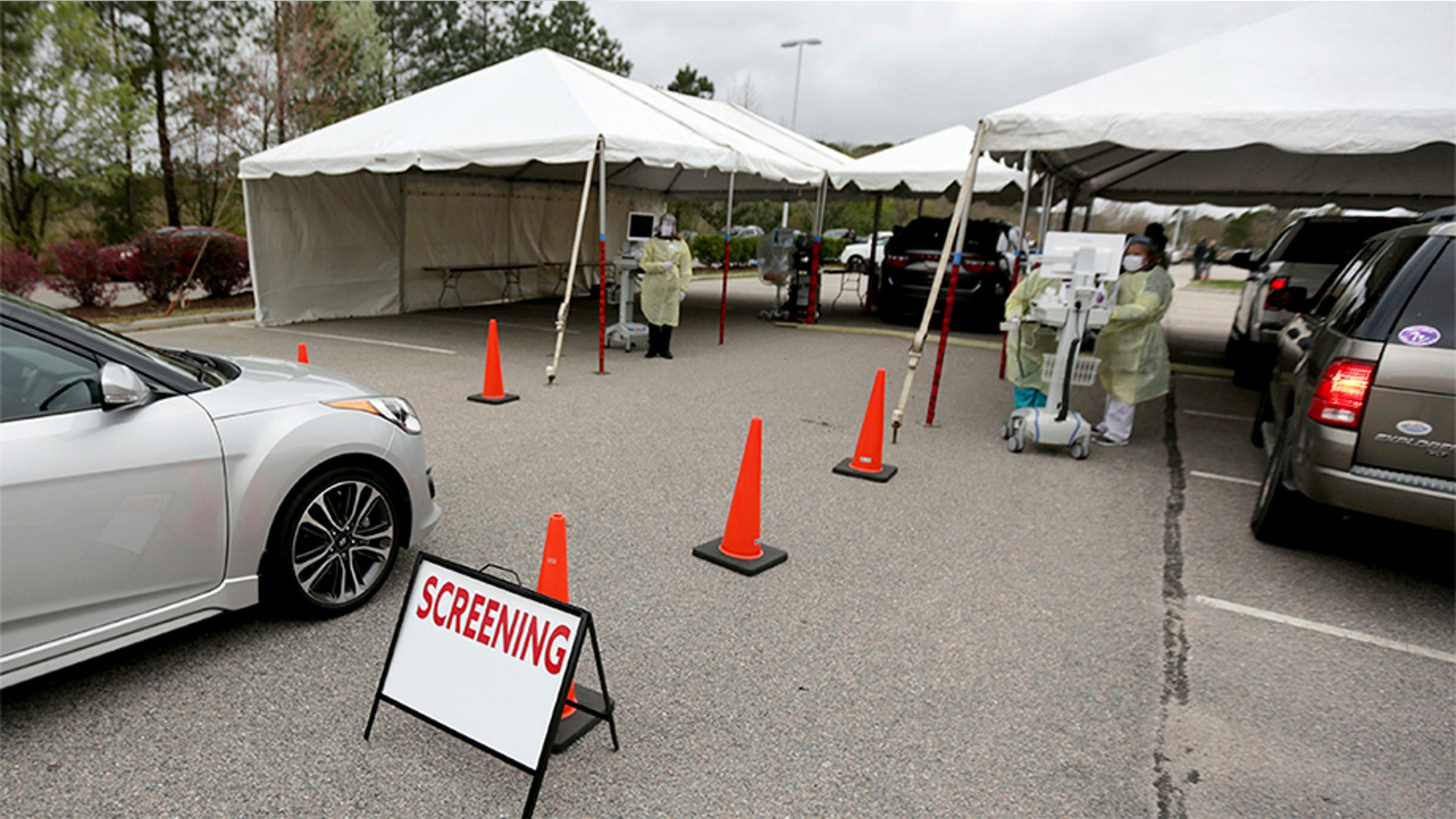 Health care providers with Sentara Princess Anne Hospital operate a drive-through testing station for patients who meet the criteria for the coronavirus in Virginia Beach, Va., March 16, 2020.