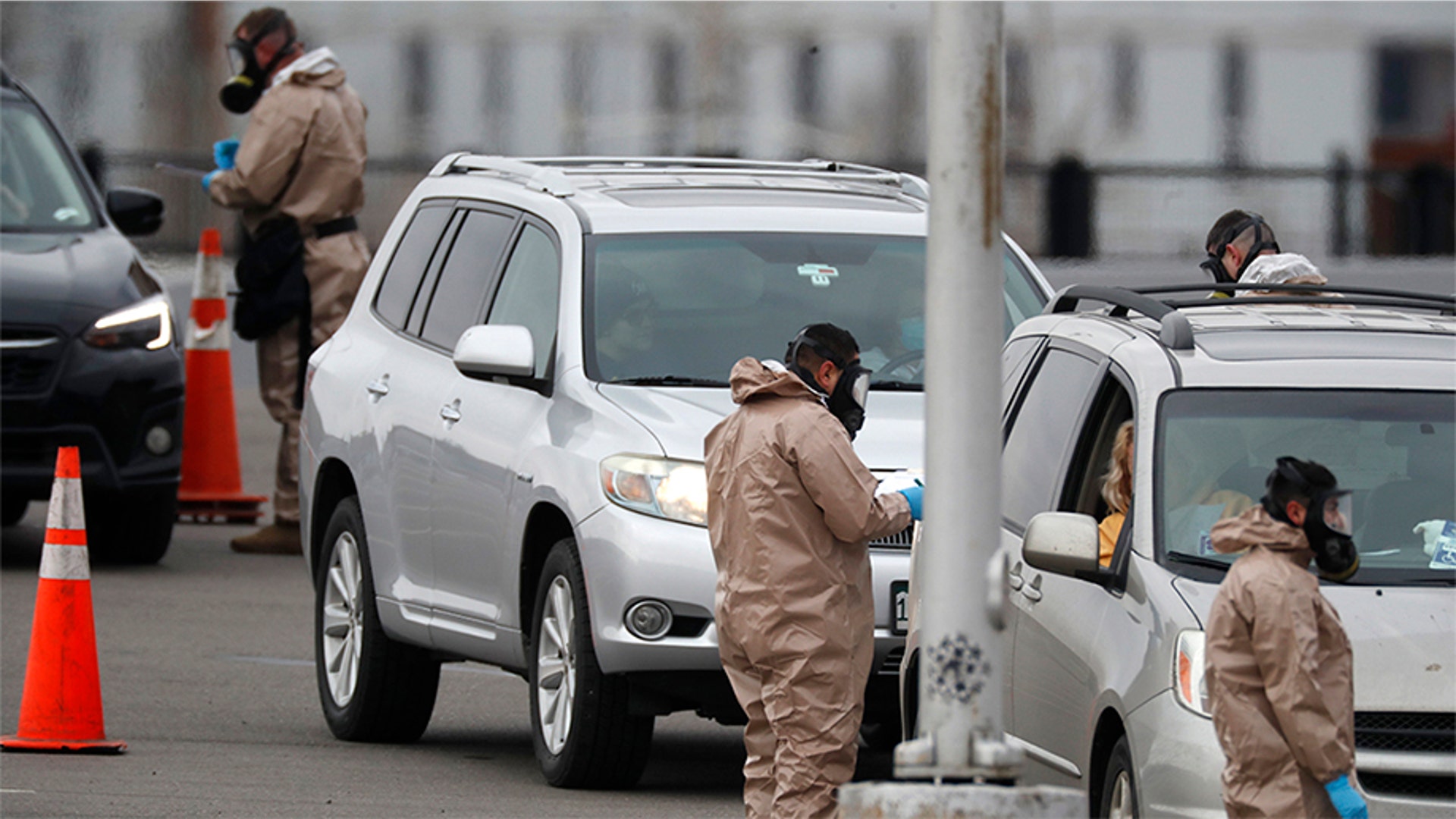 Colorado National Guard medical personnel perform coronavirus tests on motorists at a drive-through testing site outside the Denver Coliseum in Denver, Colo., March 14, 2020.