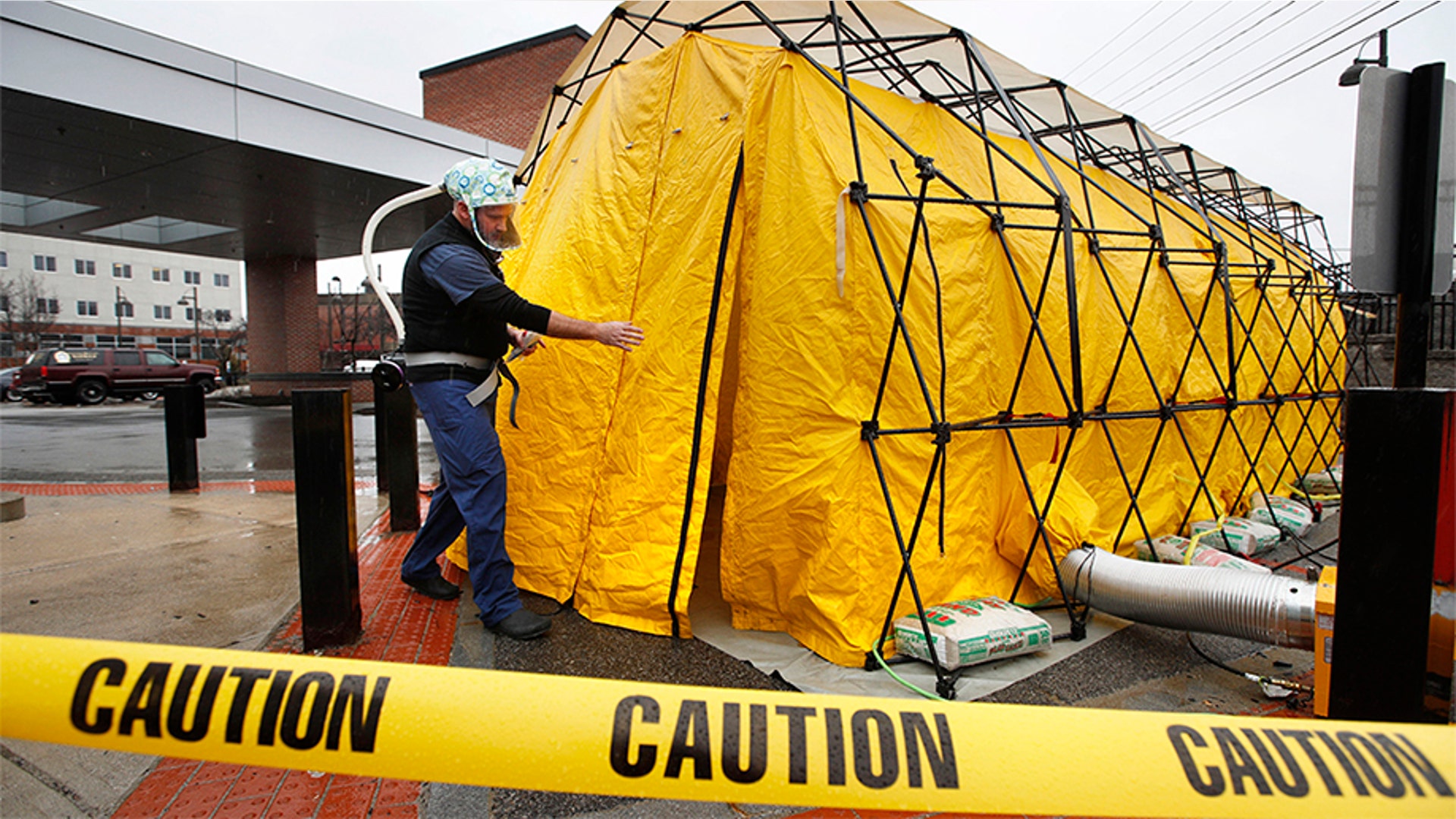 Steve Moody, director of nursing at Central Maine Medical Center, enters a tent outside the emergency entrance to the hospital to test patients who have symptoms of the coronavirus in Lewiston, Maine, March 13, 2020.