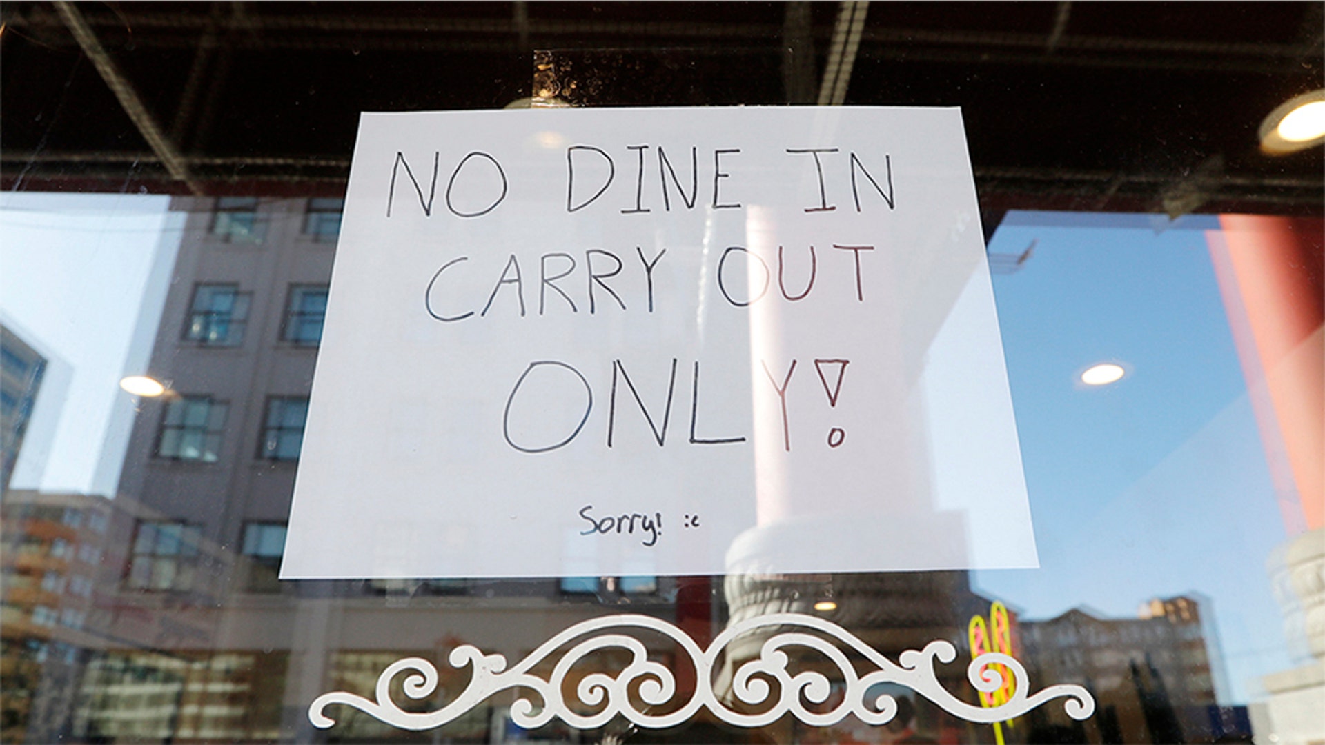 A sign posted in a restaurant window in the Chinatown-International District advises it's only offering takeout in Seattle, Wash., March 16, 2020.