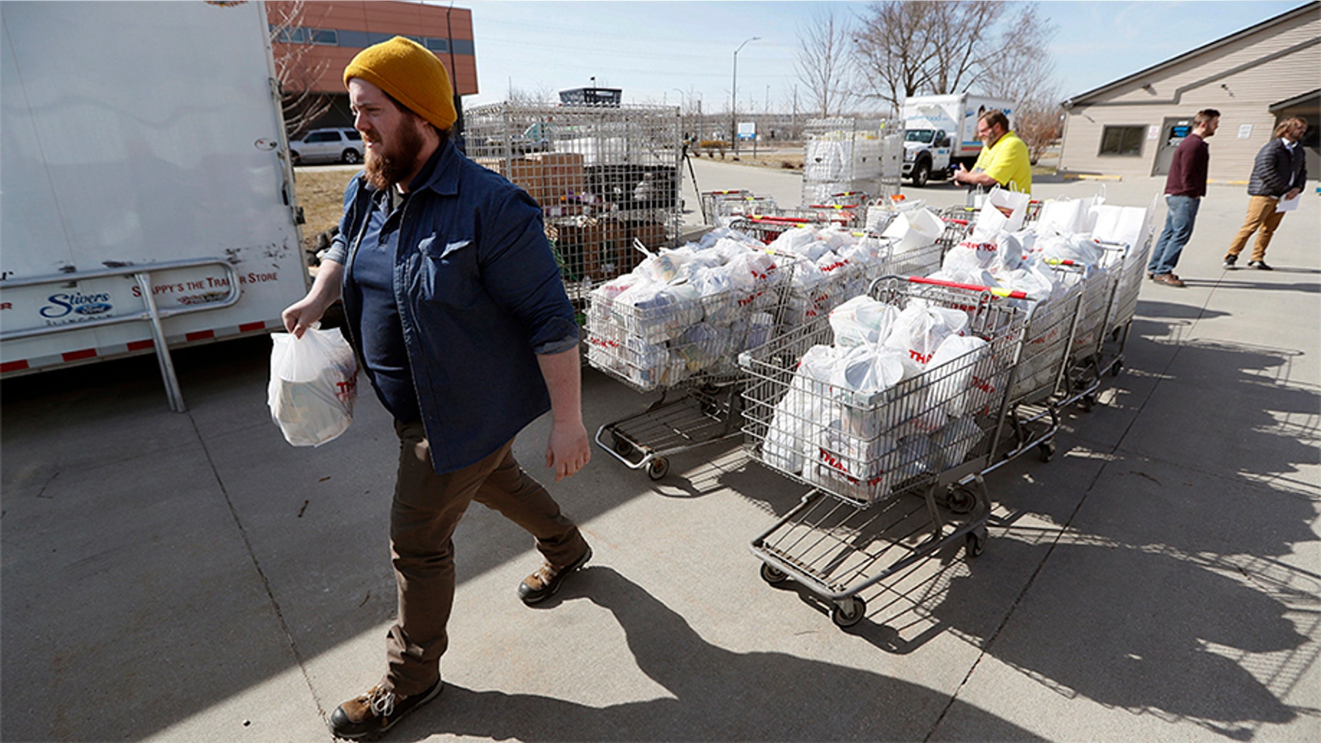 Patrick Minor loads food onto a delivery truck at the Des Moines Area Religious Council food pantry in Des Moines, Iowa, March 17, 2020.
