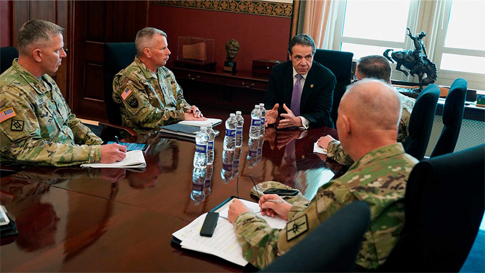 New York Gov. Andrew Cuomo, center, meets with officers from the United States Army Corps of Engineers in Albany, N.Y., March 18, 2020.