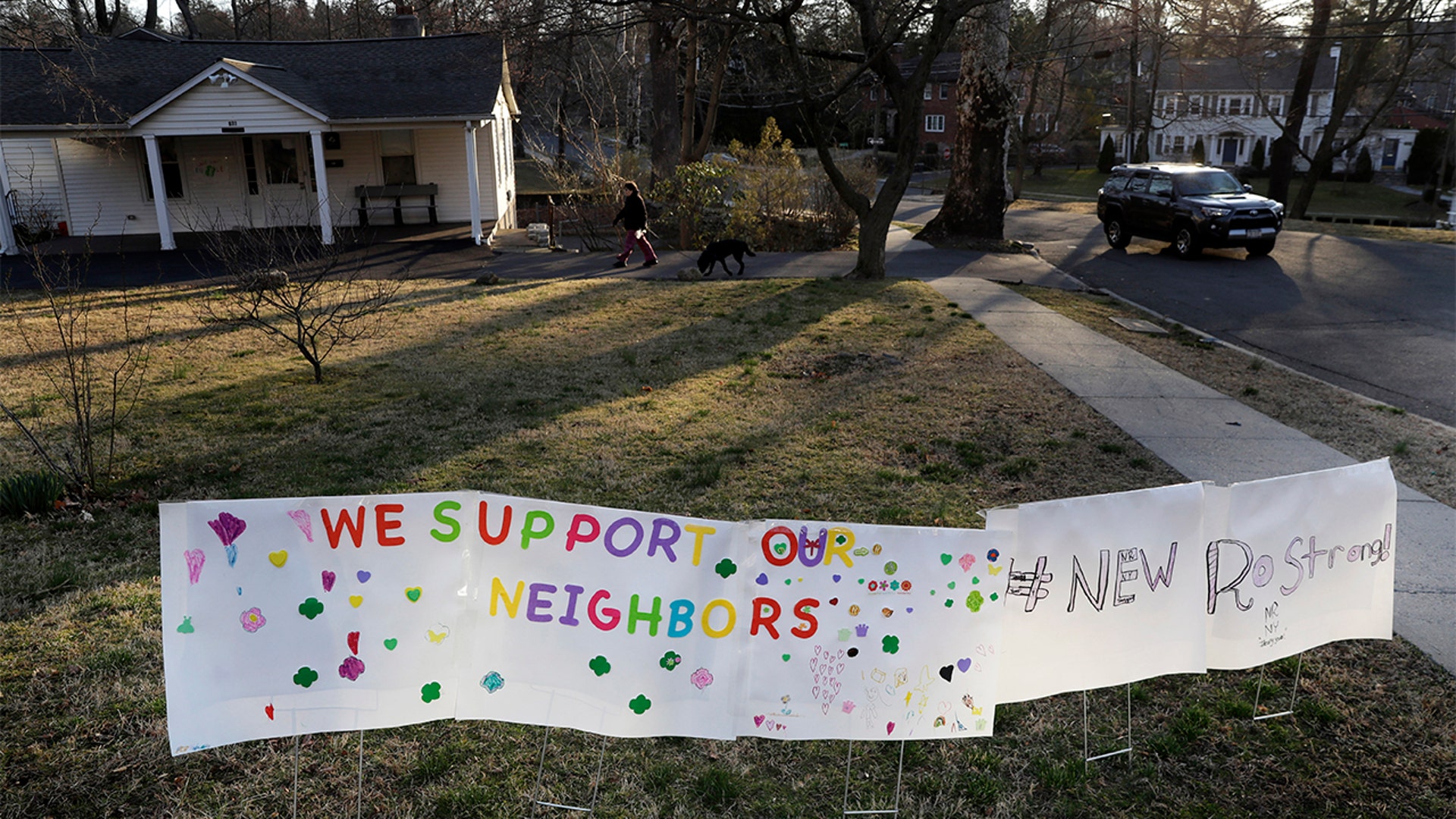 A sign showing support for residents displayed on a lawn.