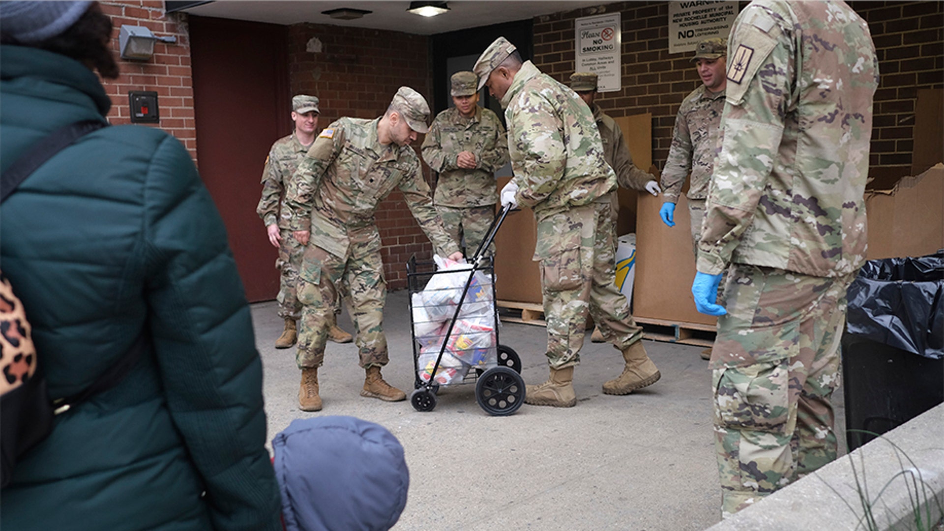 Members of the New York National Guard distributing food to families in New Rochelle.