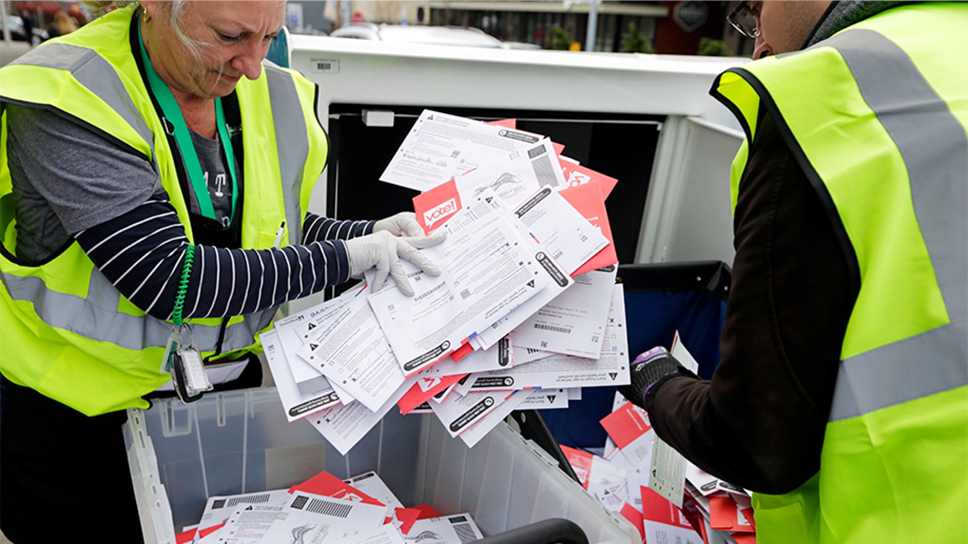 King County Election workers collecting ballots from a dropbox in the Washington State primary.