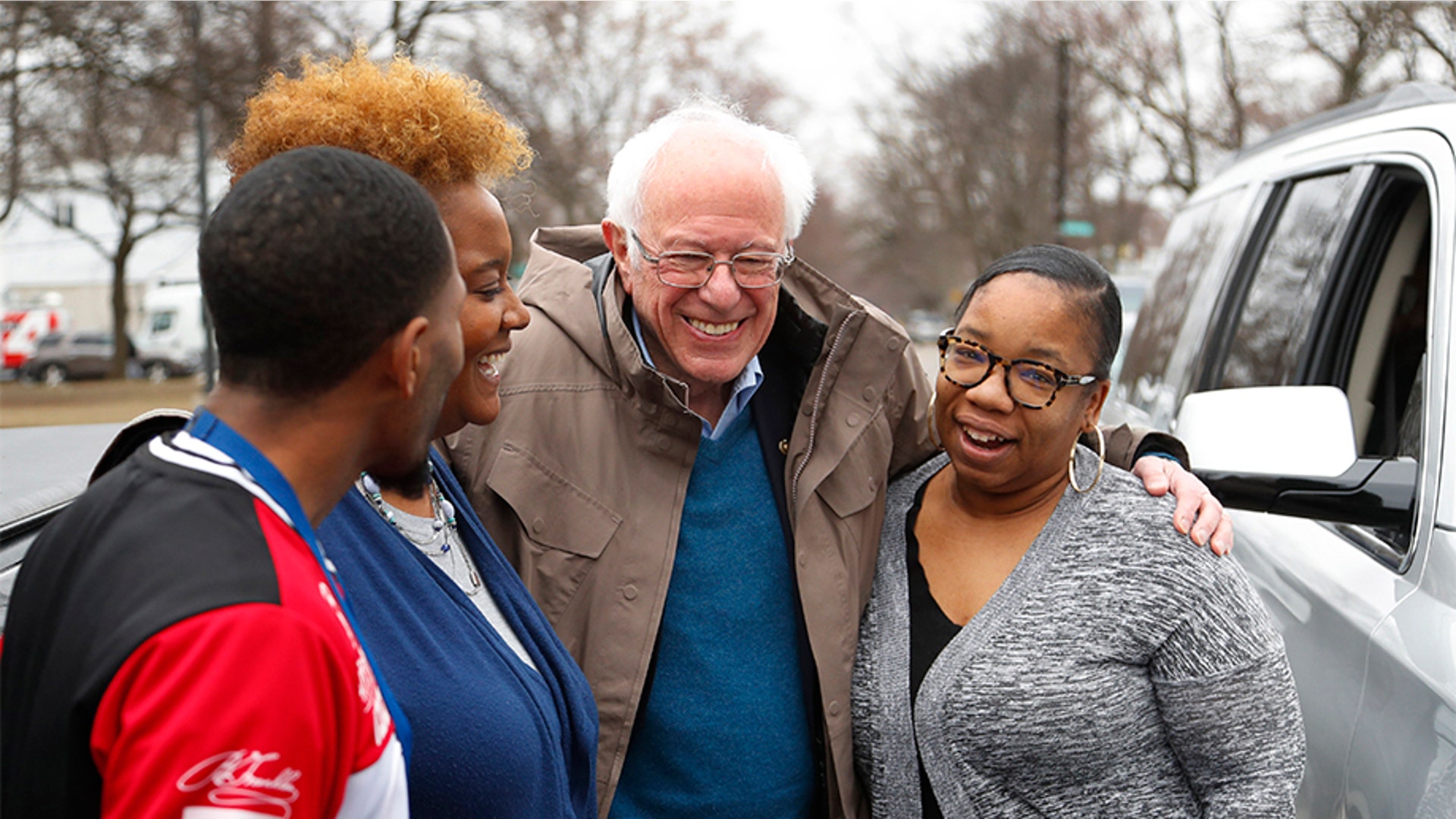 Sen. Bernie Sanders, I-Vt., visiting custodian Davonta Bynes, from left, principal DaRhonda Evans-Stewart and social worker Kim Little outside a polling location at Warren E. Bow Elementary School in Detroit.